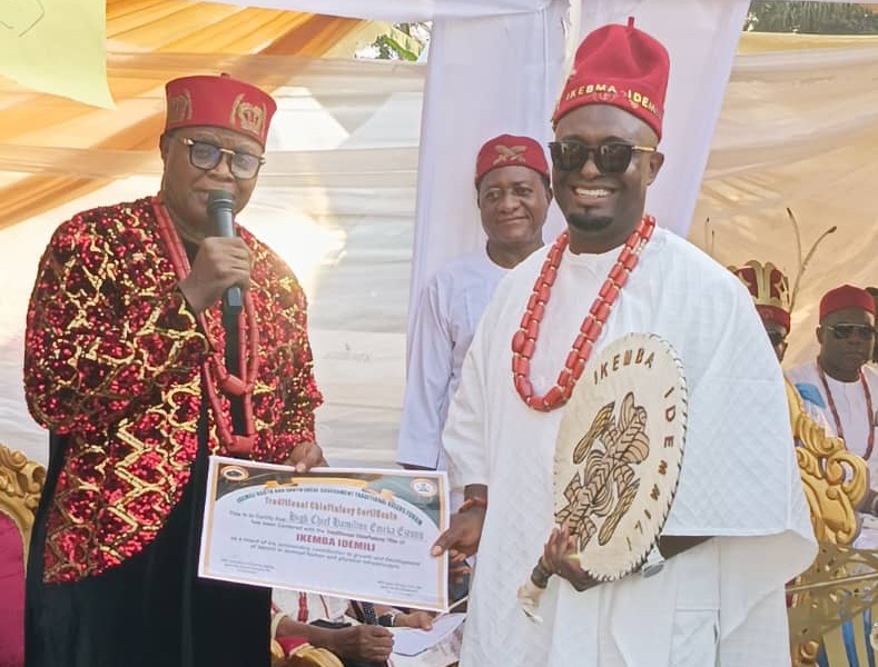 Chairman of Idemili North and South Traditional Rulers Forum, Igwe Charles Agbala handing over Certificate of Recognition to Chief Hamilton Emeka Ezeonu after his recognition as Ikemba Idemili yesterday in Abatete, Anambra State