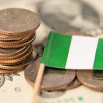bigstock-Stack-Of-Coins-With-Nigeria-Fl-392298251-scaled-1-1024×683