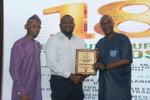 The Sales and Marketing Manager, Iron Products Industries (IPI) Ltd, Musa Umar, (middle) receiving  the Truck Assembler) Body Builder of the Year from NAJA members