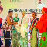 L-R Wife of the IGP, Elizabeth Egbetokun, Wife of the Chief of Naval Staff, Aisha Abbas, Wife of the Deputy Senate President, Laila Barau, First Lady of Nigeria, Oluremi Tinubu, Wife of the Chief of Defence Staff, Mrs Mernan Oluyede and the Wife of the Chief of Army Staff, Safiyyah Shaibu while the First Lady presents financial support to one of the 250 Disabled Veterans from the Military and Police in Abuja on 3rd Wednesday 2025