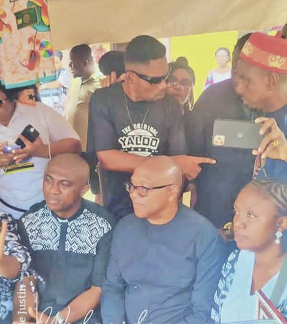 Obi (m) seated at the burial