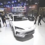 Visitors admiring a BYD EV at a motor show