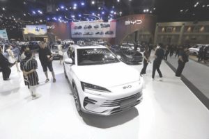 Visitors admiring a BYD EV at a motor show