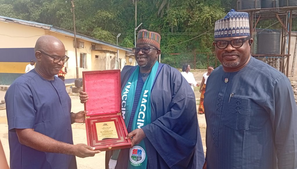 Thompson Eja, CEO of Sea Express presenting an award to the national president of NACCIMA, Jani Ibrahim while Kelly Ayamba , President of CALCCIMA looks on