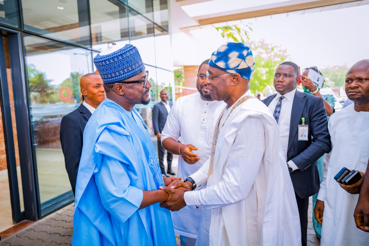 Benue State Governor Rev Fr Hyacinth Alia in a handshake with the MD REA, Mr Abba Aliyu