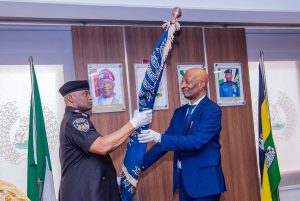 Acting IGP Tunji Disu (L) and outgoing IGP Kayode Egbetokun (R)