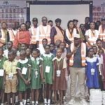 Akiba (middle) with students, parents and teachers of the selected schools