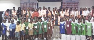 Akiba (middle) with students, parents and teachers of the selected schools