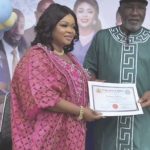 Dayo Amusa receiving cerfificate or return