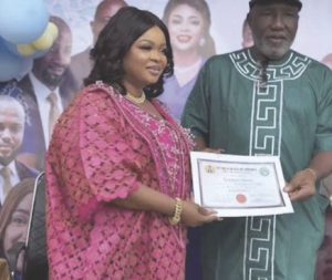 Dayo Amusa receiving cerfificate or return