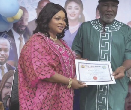 Dayo Amusa receiving cerfificate or return