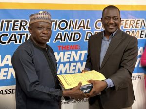 Seamless Transition at NSUK ISDEVCOM: Pioneer Executive Director Professor Emmanuel Dandaura (right) hands over to Acting Director Dr. Daniel Chikada during Friday’s boardroom ceremony in Keffi, attended by HODs, scholars, and alumni