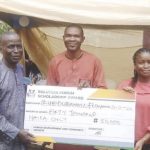 One of the beneficiaries receiving her cheque