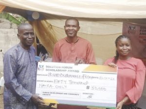 One of the beneficiaries receiving her cheque