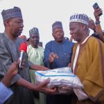 Borno governor, Babagana Zulum, handing over a bag of rice to a beneficiary during the flag off of the Food Distribution Exercise by the state government at Ramat Square, Maiduguri