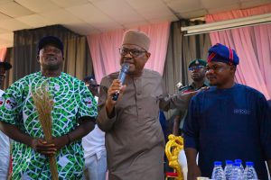 L-R: APC chairmanship candidate for Bwari Area Council, Joshua Musa, Minister of FCT Nyesom Wike (m), Julius Adamu, PDP chairmanship candidate after the later stepped down for Musa