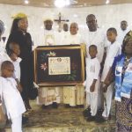 • The Bishop presenting the Papal Blessing to Kanife inside the newly dedicated church