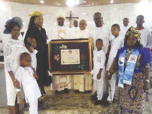 • The Bishop presenting the Papal Blessing to Kanife inside the newly dedicated church