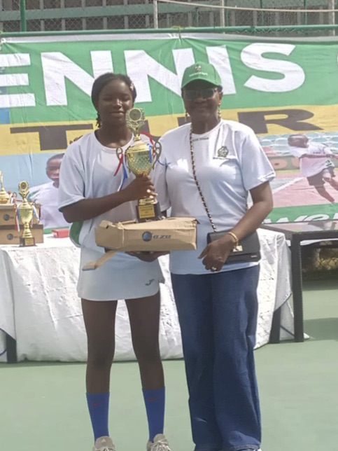 Girls U16s champion Gloria Samuel receiving her award from Mrs. Grace Otsemebor-Igbanoi, Head Event Management office.