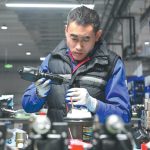 An employee assembles parts at an electric power company’s workshop in Beijing-Tianjin Zhongguancun tech town in Tianjin on Jan 30. SUN FANYUE/XINHUA.