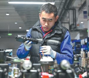 An employee assembles parts at an electric power company’s workshop in Beijing-Tianjin Zhongguancun tech town in Tianjin on Jan 30. SUN FANYUE/XINHUA.