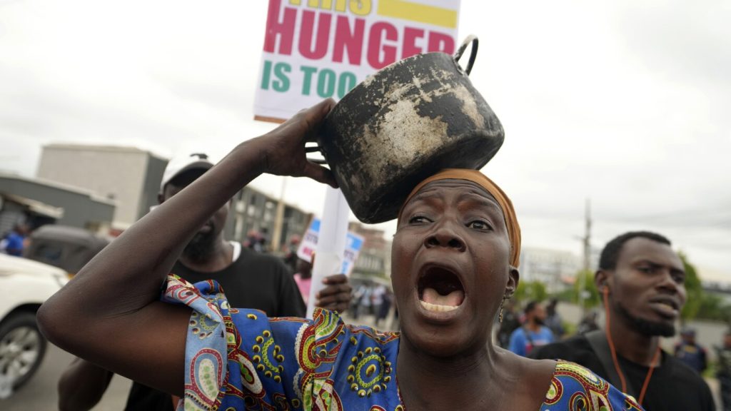 A woman protest against hardship on the street of Lagos, Nigeria, Thursday, Aug. 1, 2024. Thousands of mostly young people poured onto the streets across Nigeria on Thursday as they protested against the country’s worst cost-of-living crisis in a generation. Security forces fired tear gas to disperse some of the protesters in the capital, Abuja. (AP Photo/Sunday Alamba)