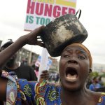 A woman protest against hardship on the street of Lagos, Nigeria, Thursday, Aug. 1, 2024. Thousands of mostly young people poured onto the streets across Nigeria on Thursday as they protested against the country’s worst cost-of-living crisis in a generation. Security forces fired tear gas to disperse some of the protesters in the capital, Abuja. (AP Photo/Sunday Alamba)