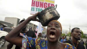 A woman protest against hardship on the street of Lagos, Nigeria, Thursday, Aug. 1, 2024. Thousands of mostly young people poured onto the streets across Nigeria on Thursday as they protested against the country’s worst cost-of-living crisis in a generation. Security forces fired tear gas to disperse some of the protesters in the capital, Abuja. (AP Photo/Sunday Alamba)