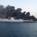 Fire billows from a struck Iranian warship off the coast of Oman