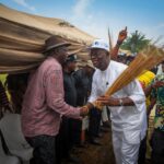 Andrew Uzamere shakes hands with a constituent