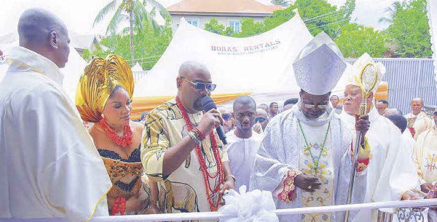 Bishop Ezeokafor cutting the tape after dedicating the church