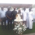 Douglas-West, wife and friends cutting the birthday cake