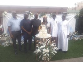 Douglas-West, wife and friends cutting the birthday cake