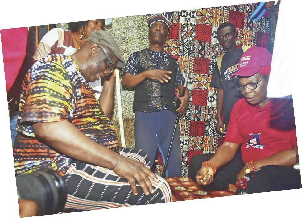 Ekiti Deputy Governor, Princess Monisade Christiana Afuye and Senator Babafemi Ojudu in a traditional game of Ayo Olopon inside Ugele cave