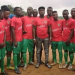 Lucky Osaro Godwin, founder of Osaro International Sports Academy, with some players from his academy.