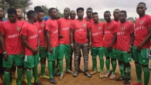 Lucky Osaro Godwin, founder of Osaro International Sports Academy, with some players from his academy.