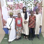 Ojeide (middle) with pupils in different traditional attires