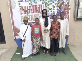 Ojeide (middle) with pupils in different traditional attires
