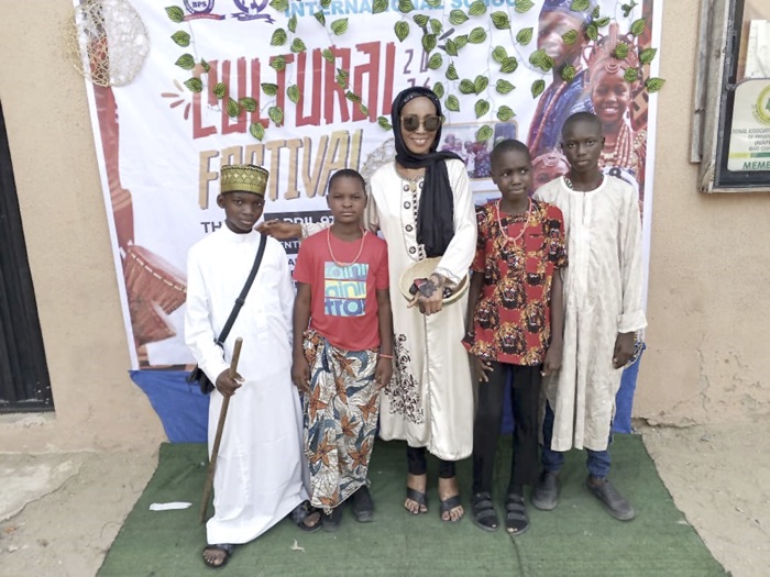 Ojeide (middle) with pupils in different traditional attires