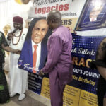 Presentation of a portrait to Mbisiogu and wife
