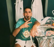 Riyad Mahrez poses with the ADC Champions League title