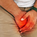 Man guarding crotch with hands