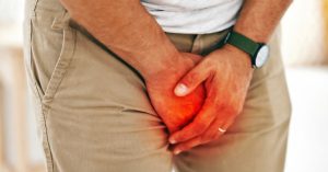 Man guarding crotch with hands