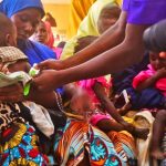 A health worker screening children for malnutrition at Gwange PHCC Dama