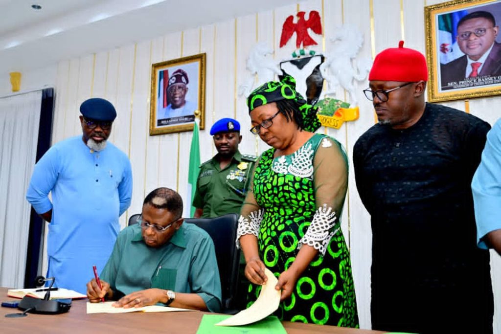 Gov. Otu assenting to the new laws in the presence of the Speaker of the State Assembly Elvert Ayambem, the Chief of Staff Emmanuel Ironbar and others