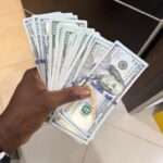 Burna Boy gives Nasboi stack of dollar bills