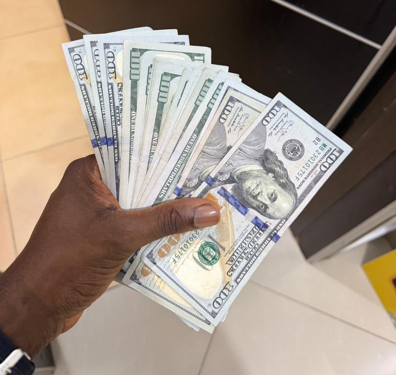 Burna Boy gives Nasboi stack of dollar bills