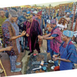 Akinboboye (left) and other guests moving round to taste the Asun delicacy