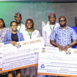 Ayodele Ogunsan, presenting cheques to the prize winners.
