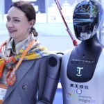 An attendee poses for a photo with a humanoid robot at the 10th China-Russia Expo in Harbin, Northeast China’s Heilongjiang Province. (Xinhua/Zhang Tao)